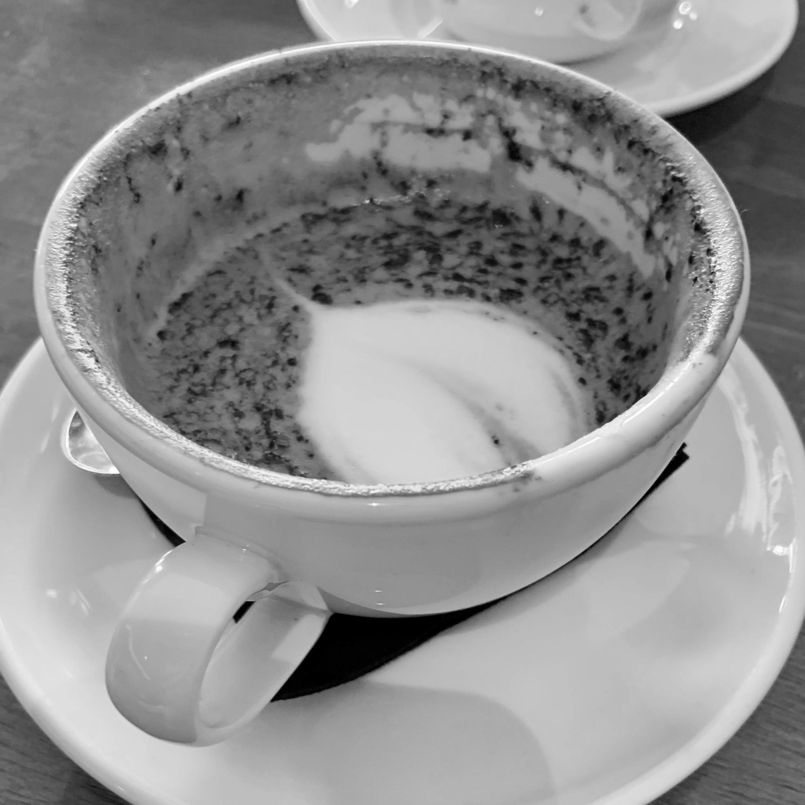 A monochrome image of a coffee cup.